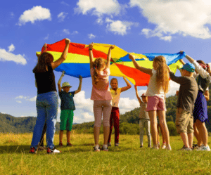 Children playing outside with parachute