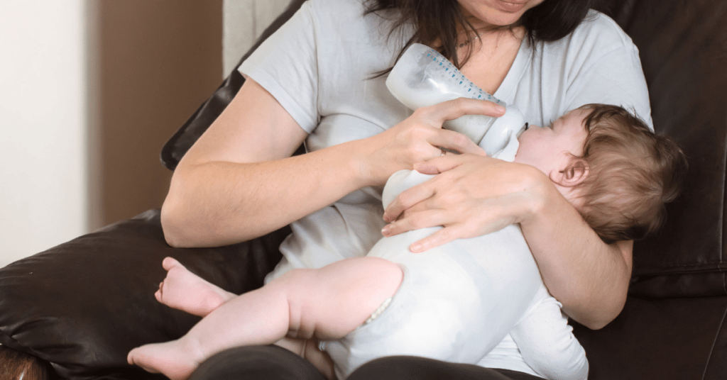 Mom bottle feeding child