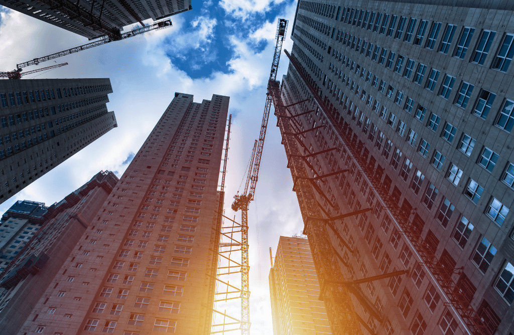 Photo at a Bronx job site looking up at cranes