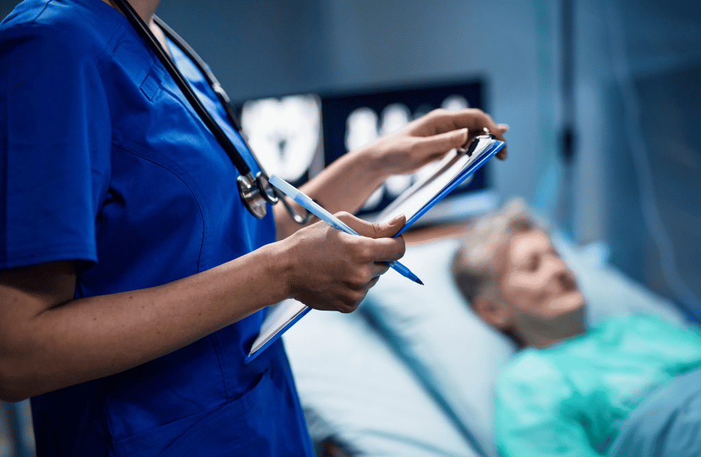 Photo of a doctor and patient in hospital bed