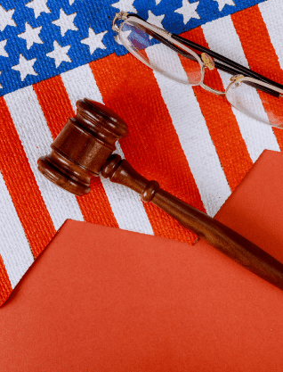 A gavel, the U.S. flag, and a pair of glasses