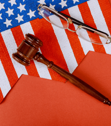 A gavel, the U.S. flag, and a pair of glasses