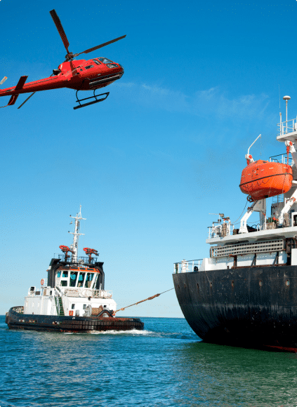 A helicopter flying over a boat