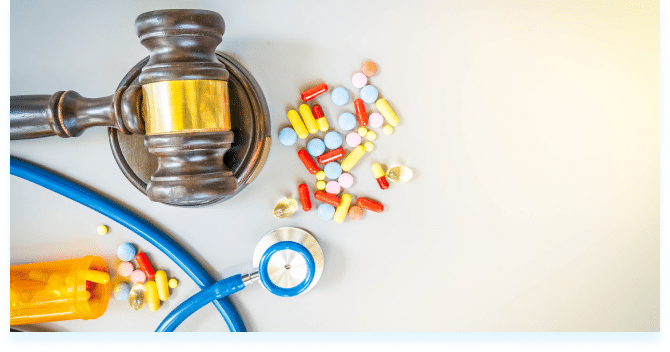 A gavel next to prescription pills and a stethoscope