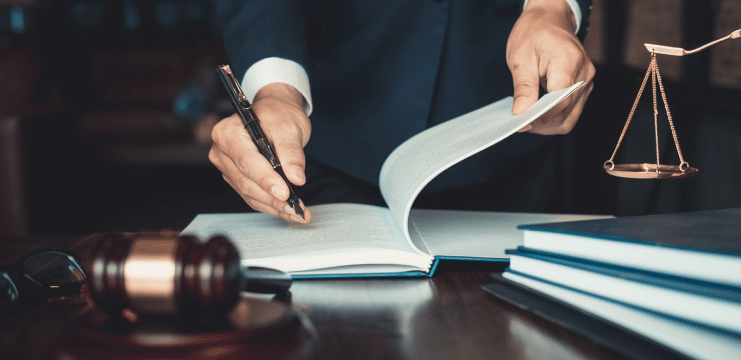 A lawyer signing a book